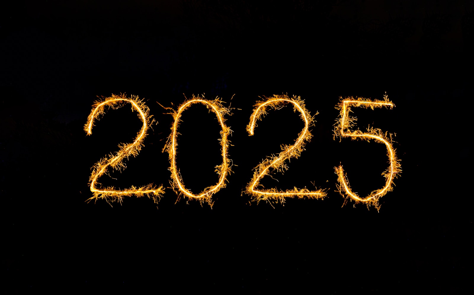 A black background with the number 2055 written in sparklers